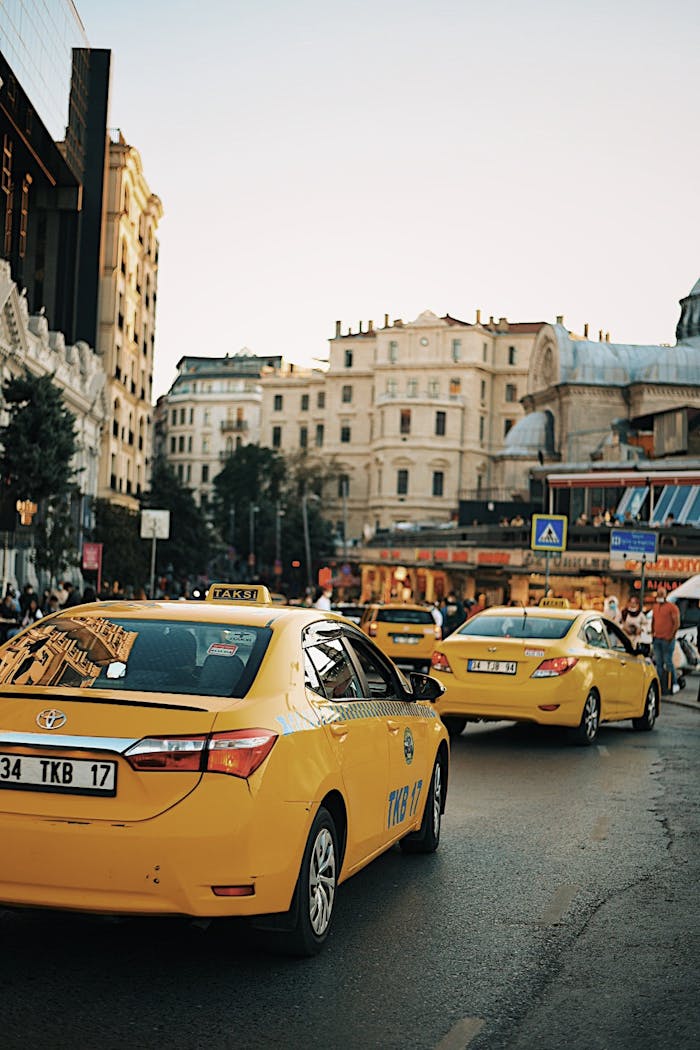 Istanbul street featuring yellow taxis and classic architecture, capturing urban life.